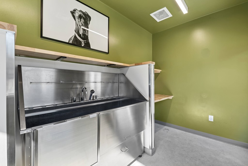 A kitchen with a stainless steel counter and a fridge.