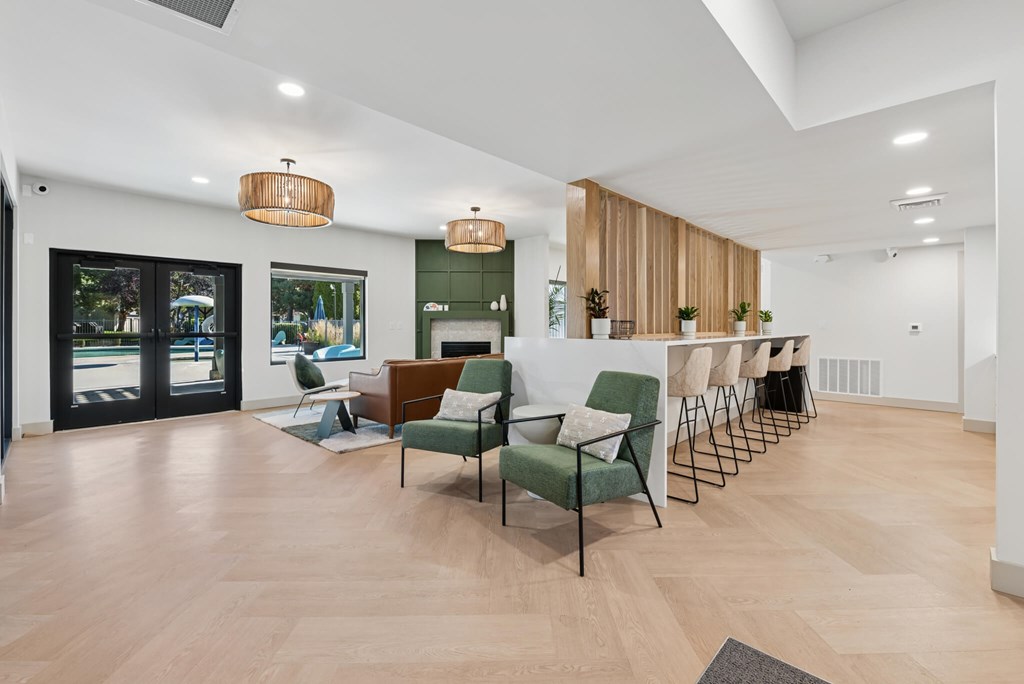 A modern living room with a green chair in the center.