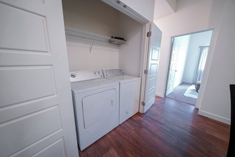 A small white washer and dryer in a laundry room.