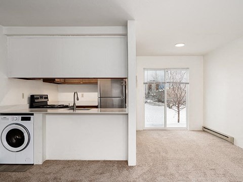 White Kitchen with a washing machine at Peaks at Ellis View, Bozeman