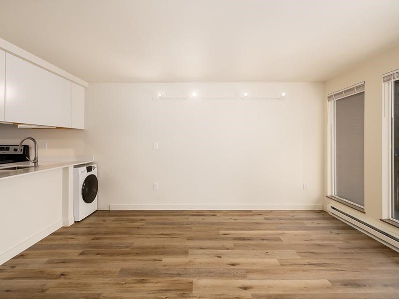 A room with a washing machine and a window.