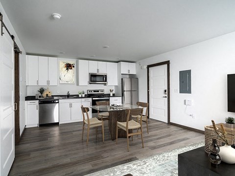 A modern kitchen with a dining table and chairs.