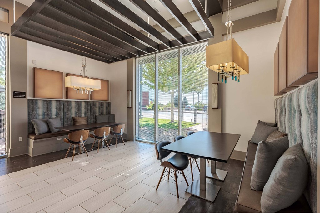 A modern dining room with a long table and chairs.
