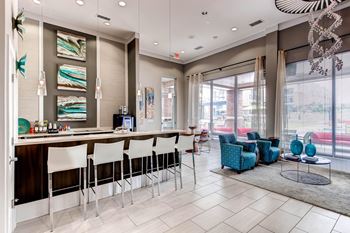 A modern living room with a bar area and comfortable seating.