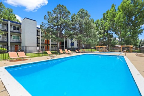 A swimming pool in front of apartment buildings.