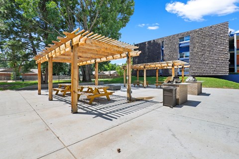 Outdoor grilling station with pergola covered seating area at Peaks on Drake Apartments, Colorado, 80525
