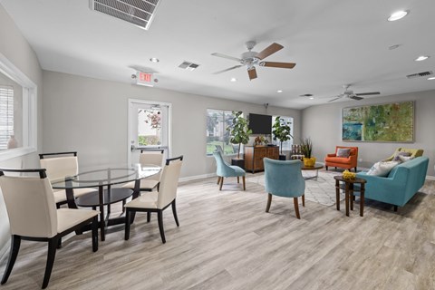 A living room with a glass table and chairs.