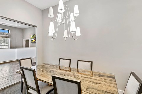 A dining room with a wooden table and chairs.