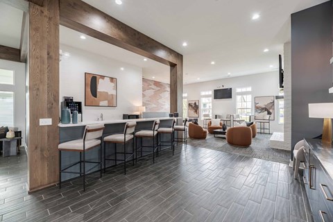 A modern kitchen with a long table and chairs.