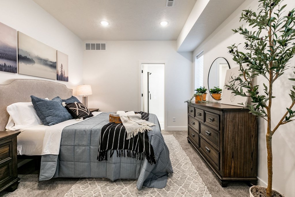 a bedroom with a bed and a dresser