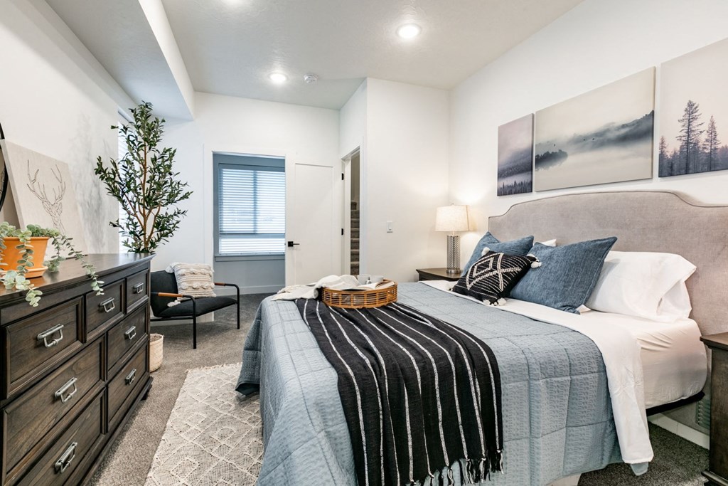 a bedroom with a bed and a dresser