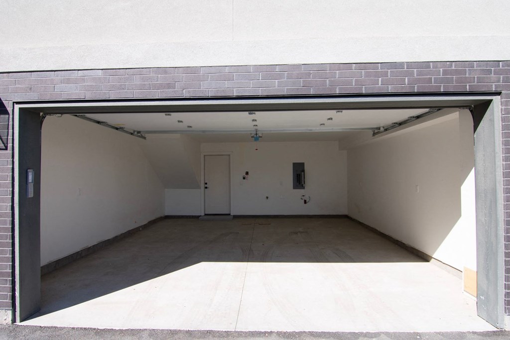 the inside of an empty garage with the door open