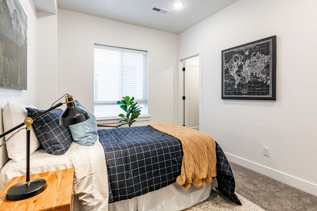 a bedroom with a bed and a window