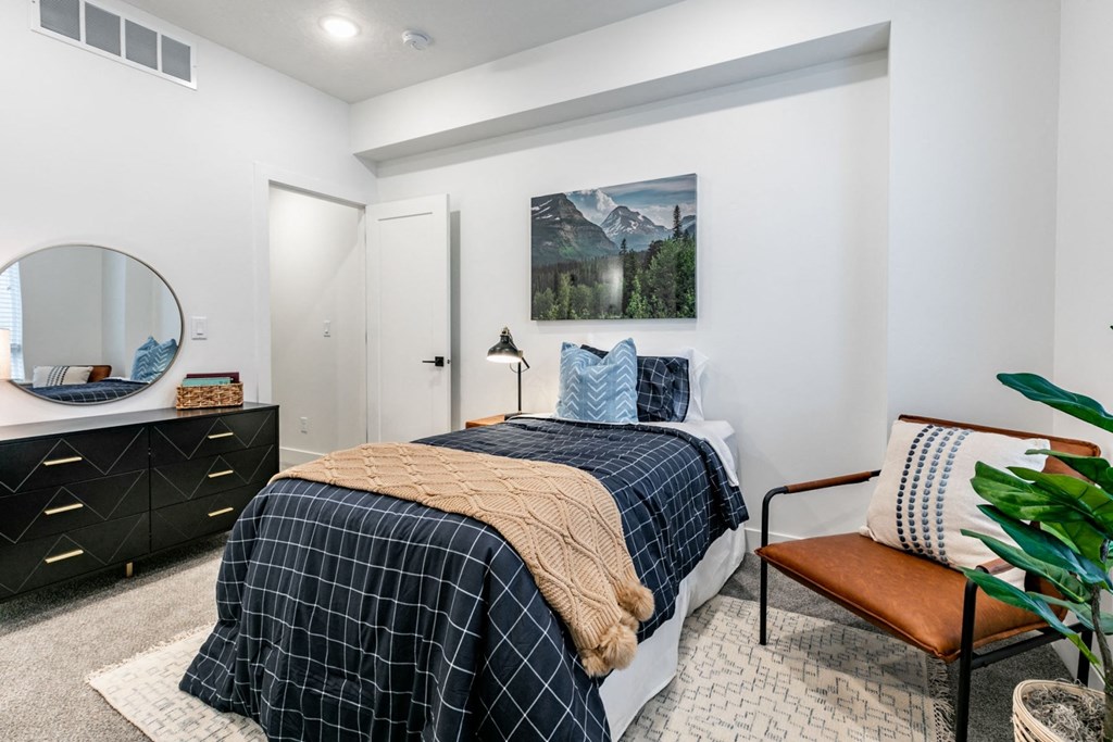 a bedroom with a bed and a dresser