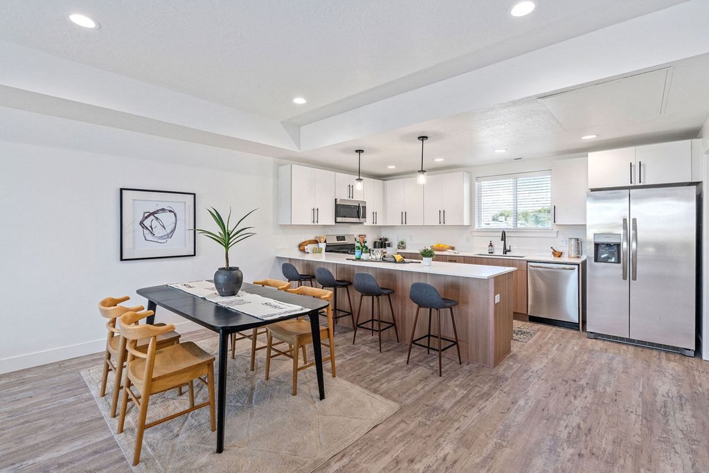 an open kitchen and dining area with a table and chairs