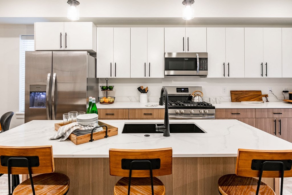 a kitchen with white cabinets and a white counter top