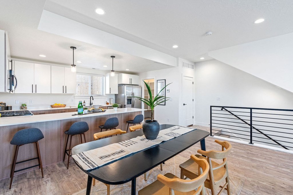 a kitchen and dining room with a table and chairs