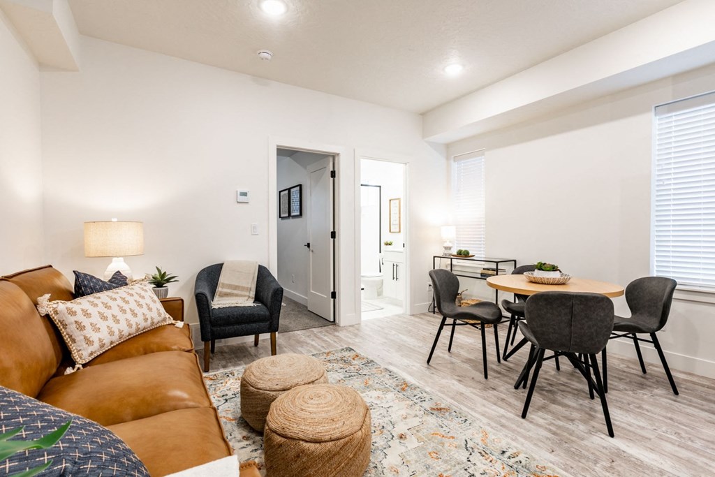 a living room with a couch and a dining room table