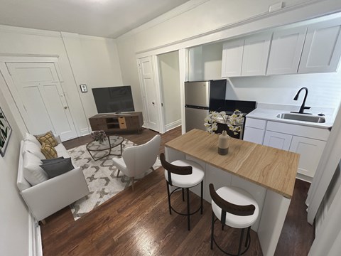 A kitchen with a bar stool and a counter.