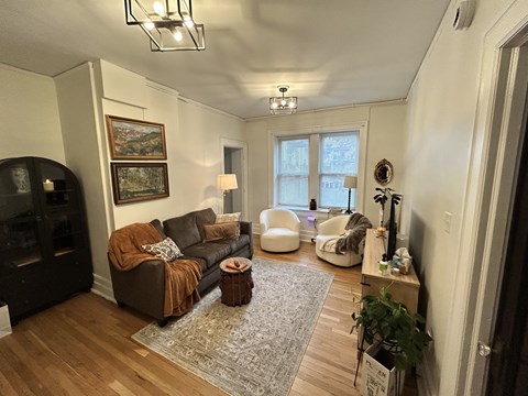 A living room with a brown couch and a fireplace.