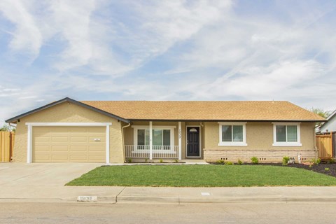 A house with a brown roof and a garage door.