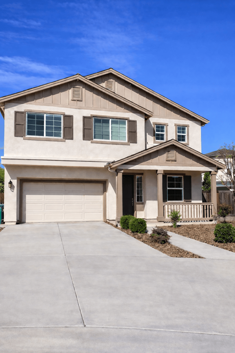 A two-story house with a garage on the left side.