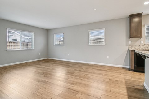 A room with wooden flooring and a fireplace.
