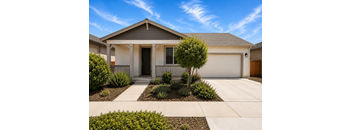 A house with a front yard and a driveway.