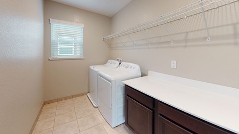 A small laundry room with a washer and dryer.
