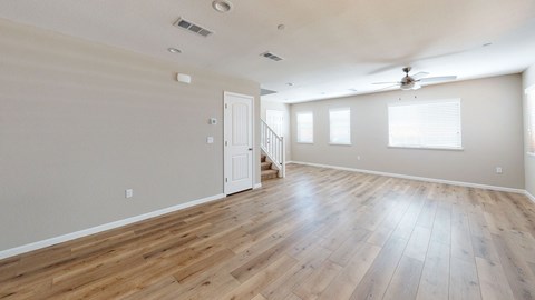 A room with wooden floors and a ceiling fan.