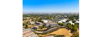 A bird's eye view of a residential area with a large building in the center.