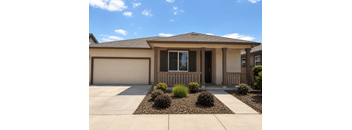 A house with a brown roof and a white garage door.