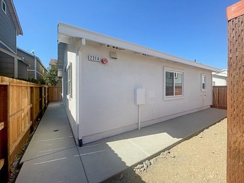 A small white building with the number 231A on it.
