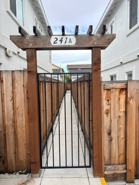 A wooden gate with the number 2411 on it.