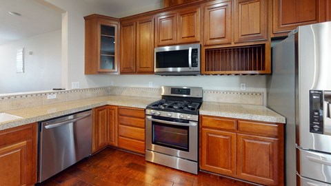 A kitchen with wooden cabinets and stainless steel appliances.