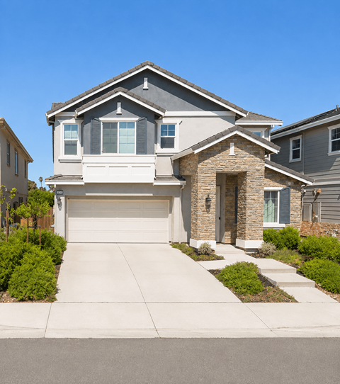 A modern house with a grey roof and a stone pillar entrance.