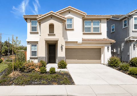 A two-story house with a garage and a driveway.