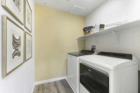 A white oven is in a kitchen with a shelf above it.