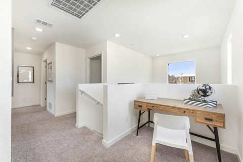 A room with a desk and chair in it.