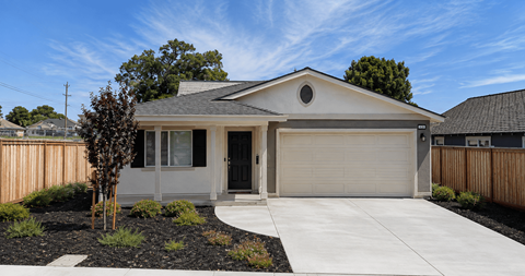 A house with a grey front door and a garage door.