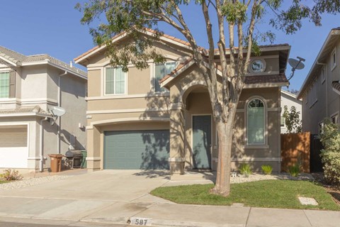 A house with a tree in front of it.