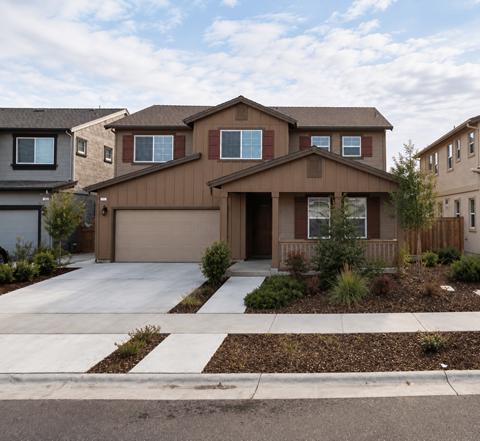 A brown house with a white garage door in front.