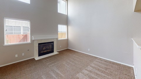 A living room with a fireplace and carpeted floor.