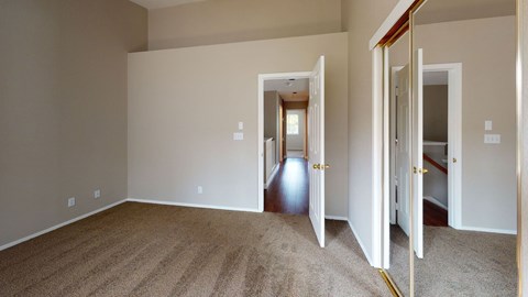 A room with carpeted floor and white walls.