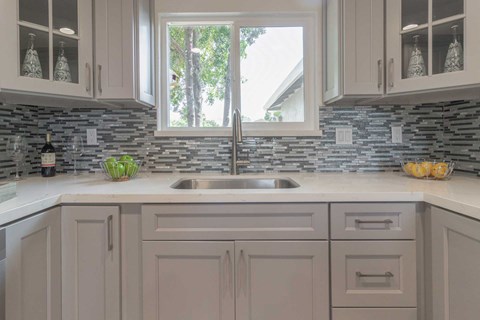 A kitchen with a sink and a window.