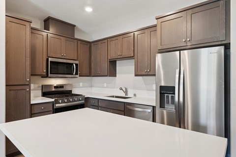 A kitchen with brown cabinets and a white countertop.