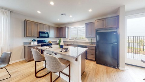 A kitchen with a table and chairs.
