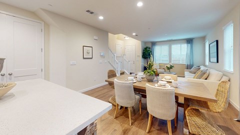 A dining room with a table set for six.