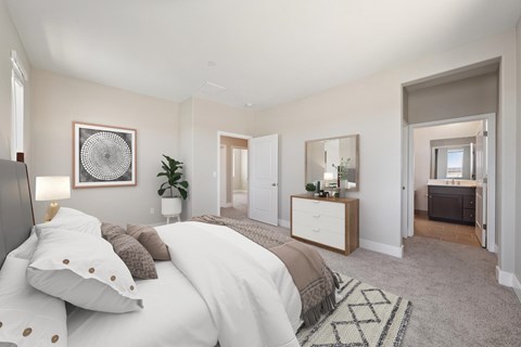 A bedroom with a large bed and a mirror on the wall.