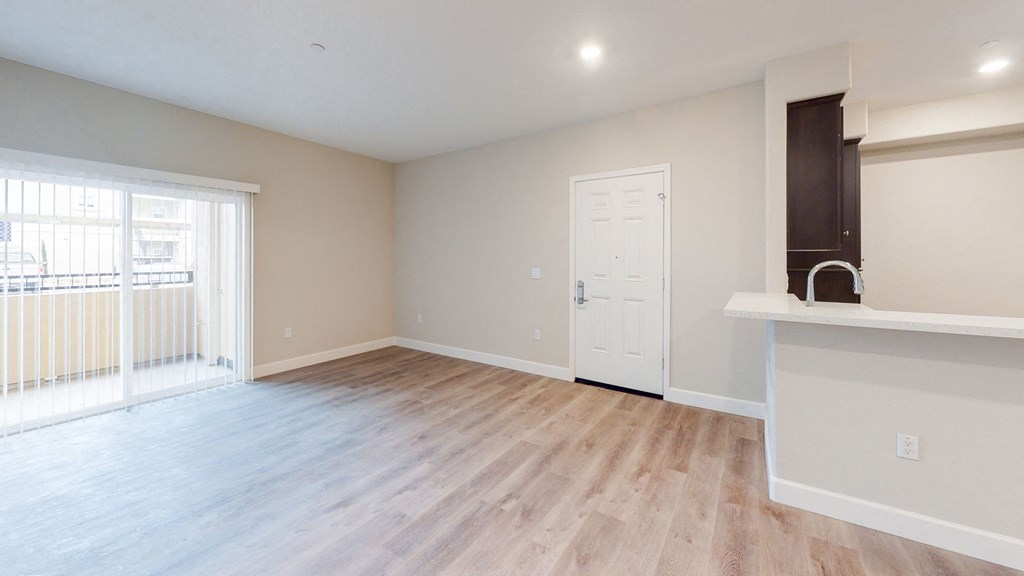 the living room and kitchen of a new home with wood flooring at Heritage Landing Apartments, California, 95973